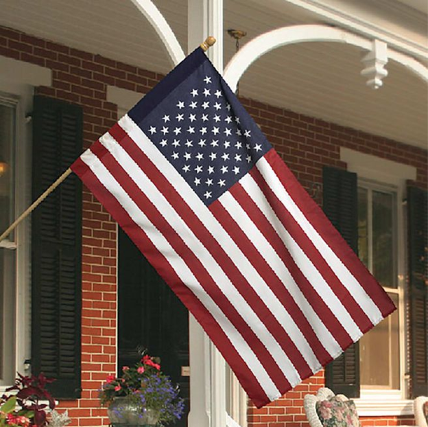 American flag hanging off of house