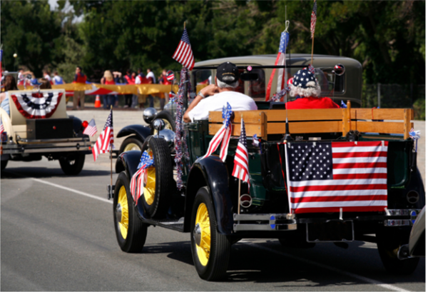 2 people in car with American flags